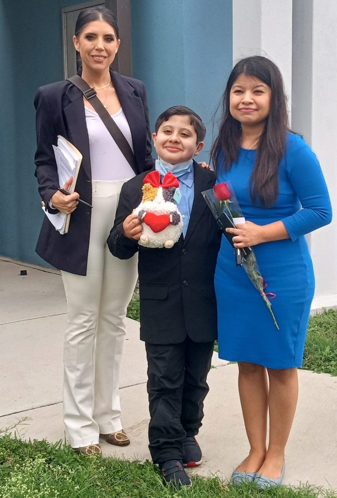 Three people standing outside a courtroom.