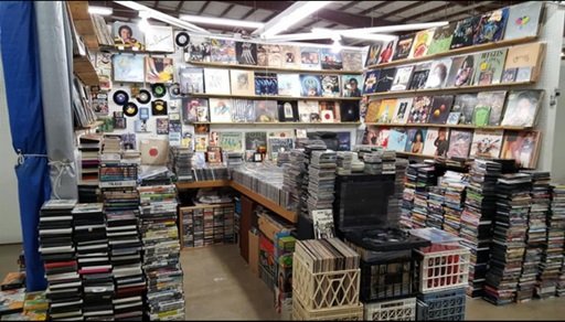 Records scattered and stacked at a record shop.