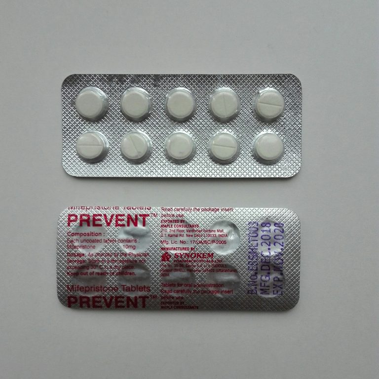 Two packages of white medication tables.