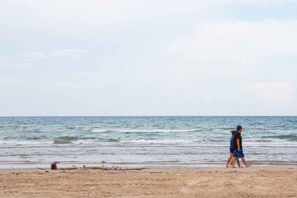 Blue water and light brown sand, birds and people make up a nice day at Boca Chica Beach.