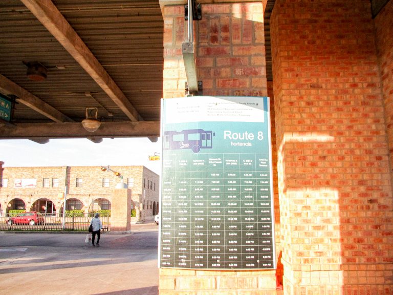 Route 8, Hortencia shown clearly during a sunny bright afternoon, a woman in the background is seen carrying a white plastic bag.