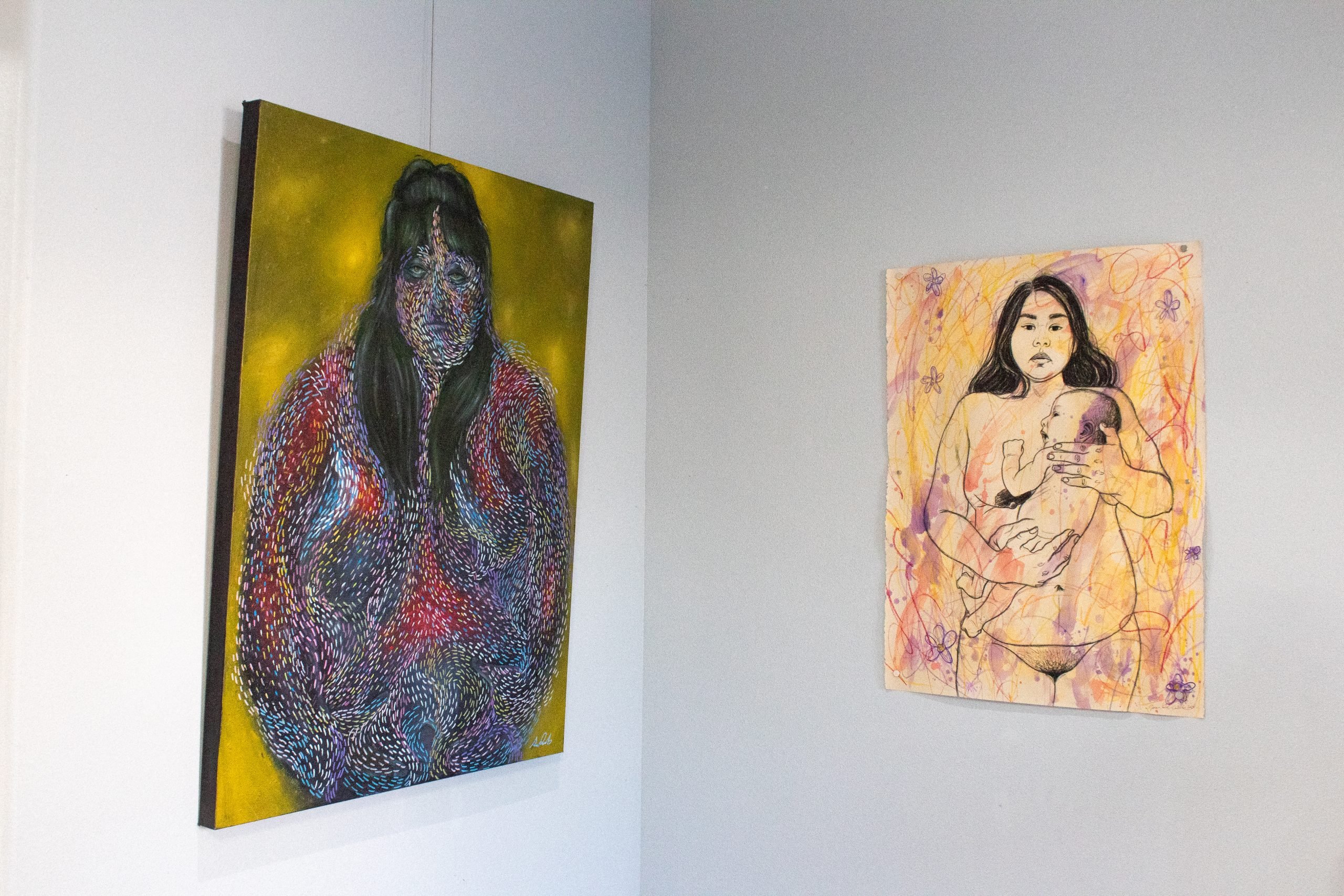 A photo of two artworks hanging on a studio’s walls.
