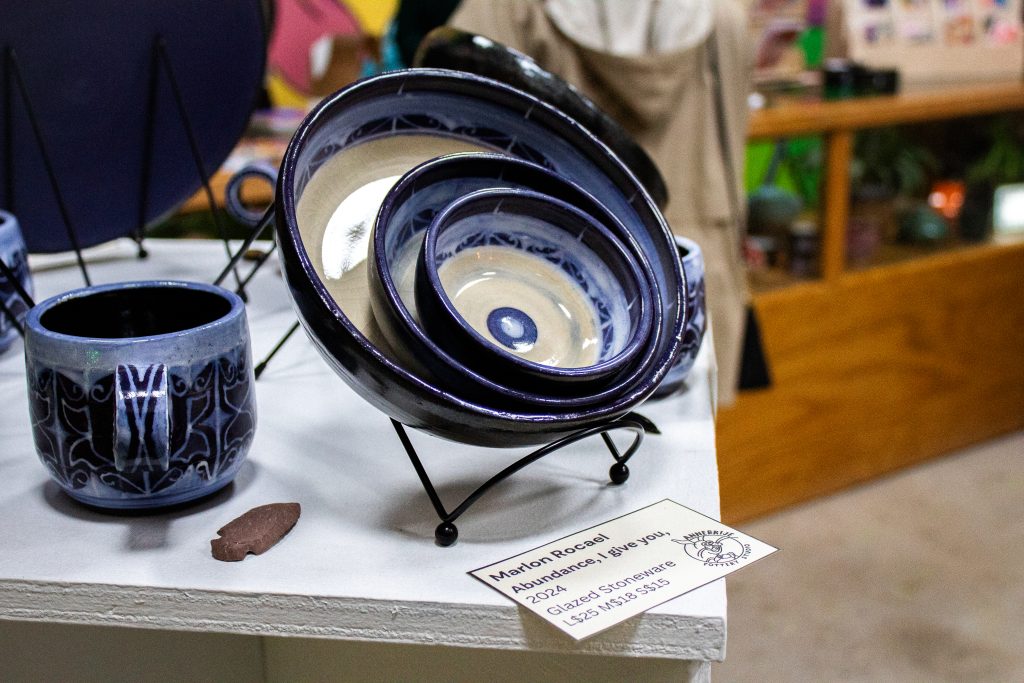 Three black, white, and blue bowls stacked on top of each other and displayed together.
