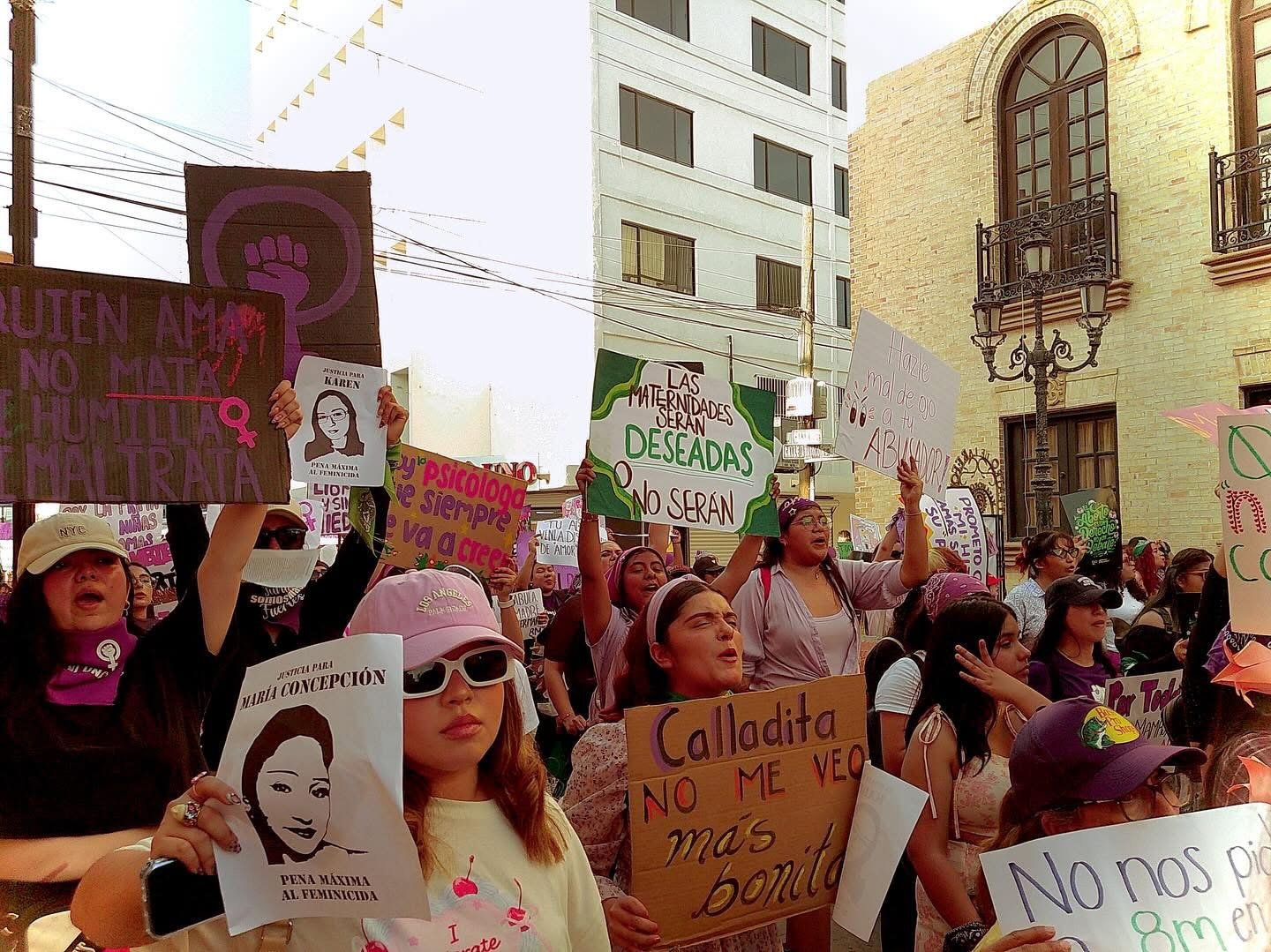 A close-up of women in Matamoros holding feminist signs and banners.