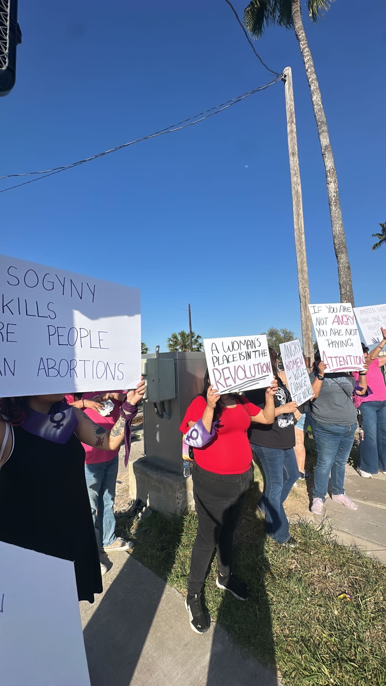 RGV women hold signs demanding women’s rights in McAllen.