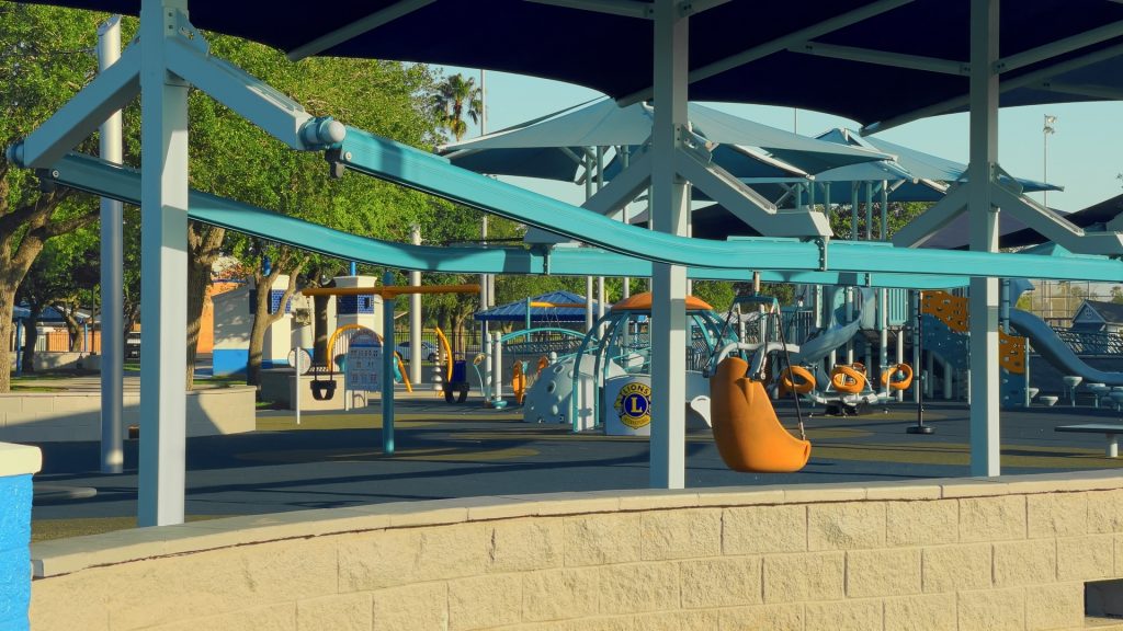 A wide view of the colorful all-inclusive Lions Park in Mission, Texas, featuring an accessible zipline.