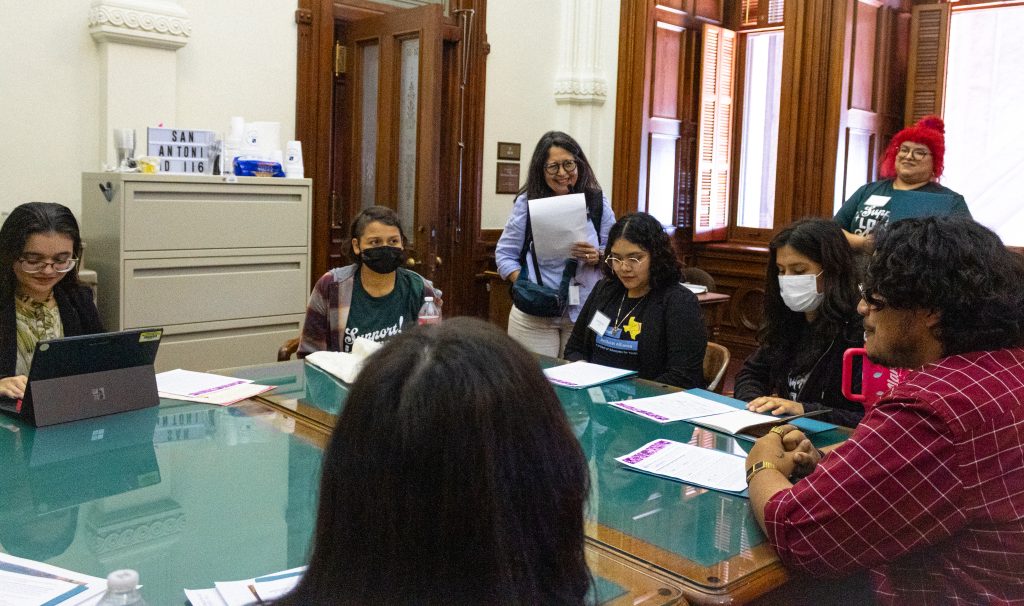 People sitting around a table strategizing and engaging in lively conversation.