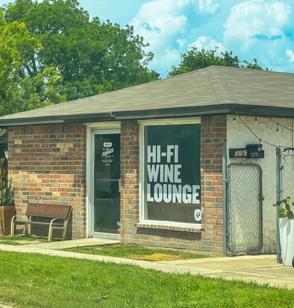 A storefront from a brick building. The windows say "Hi-Fi Wine Lounge"