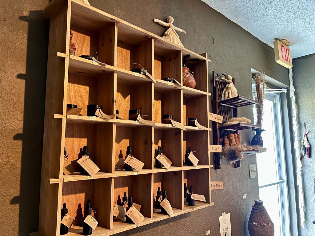 A wooden display with various medicines.