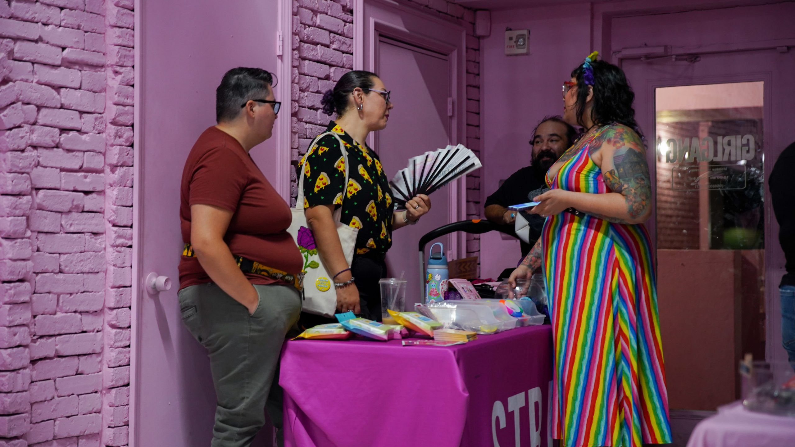 A small group of people conversing privately at the STRJ table.