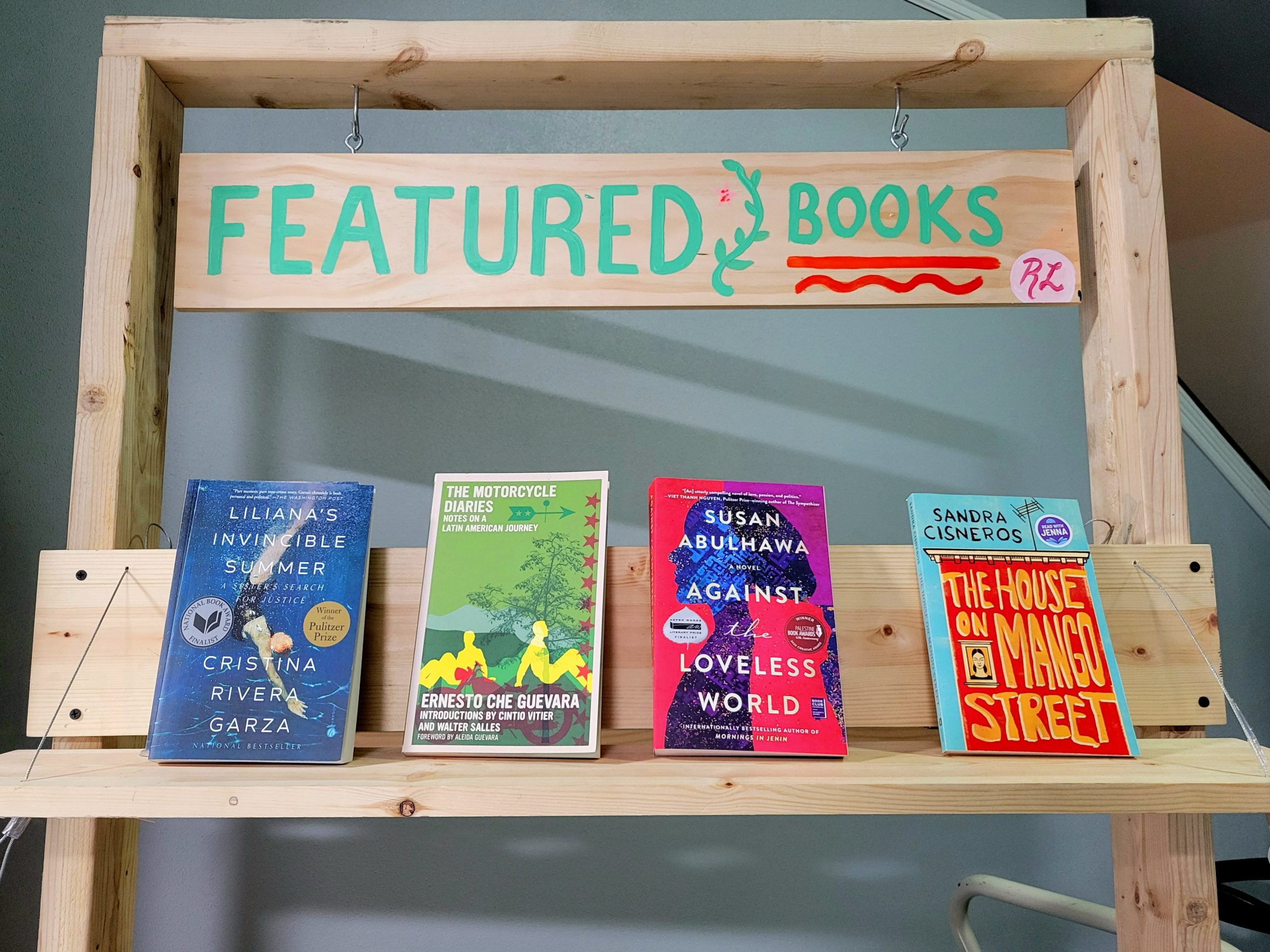 A wooden book display with the words “Featured Books” at the top.