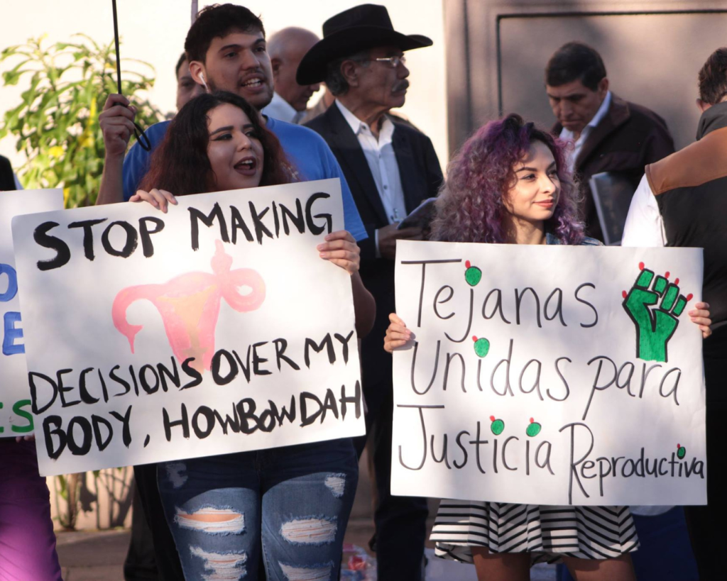 People protesting for reproductive rights, holding signs.