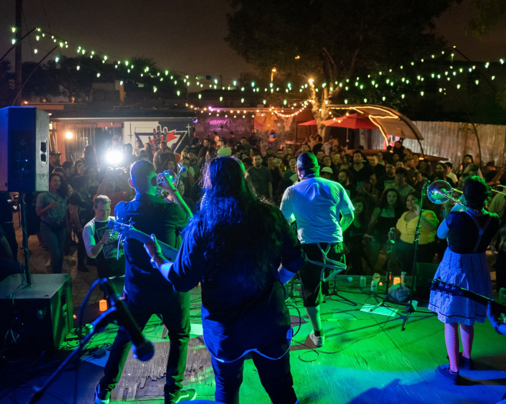A band playing to a large group of people.