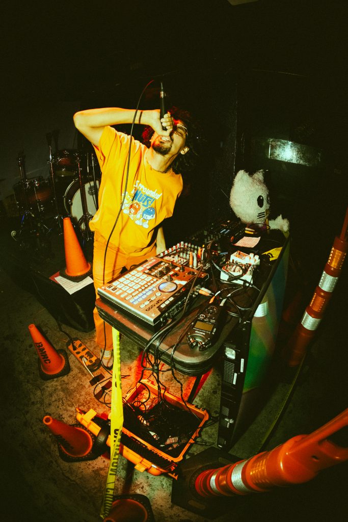 A photo of b11ce holding a mic, singing at The Jukebox Bar.