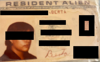 The Resident Alien card of a woman whose name has been concealed.