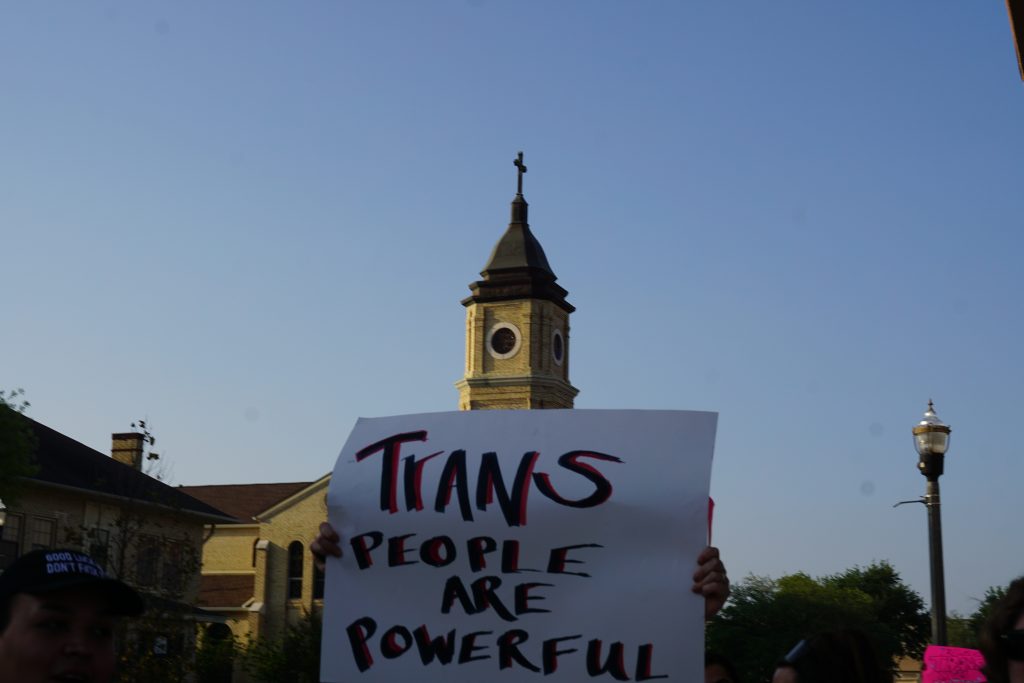 A poster held in front of a church in downtown McAllen boldly states: “TRANS PEOPLE ARE BEAUTIFUL.”