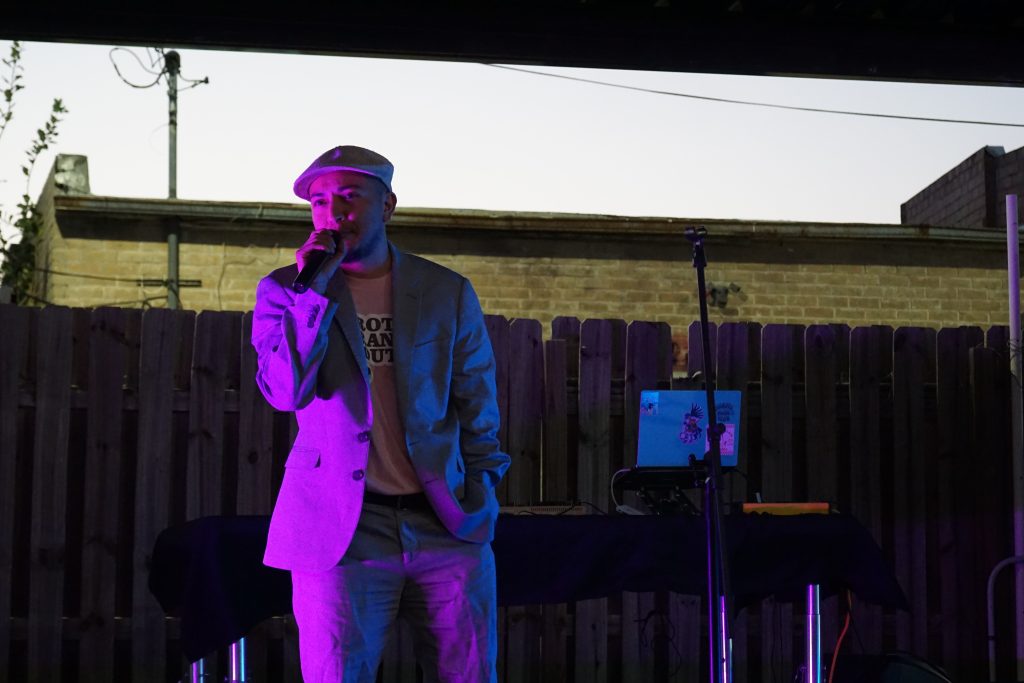 Event Co-Organizer Adrian Melgar from GENTex and Casa Kimberly stands onstage and gives a speech at the Gremlin.