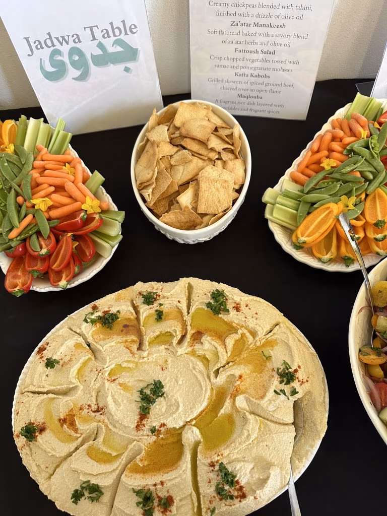Five dishes on a table made out of chopped vegetables, flatbread and beef.