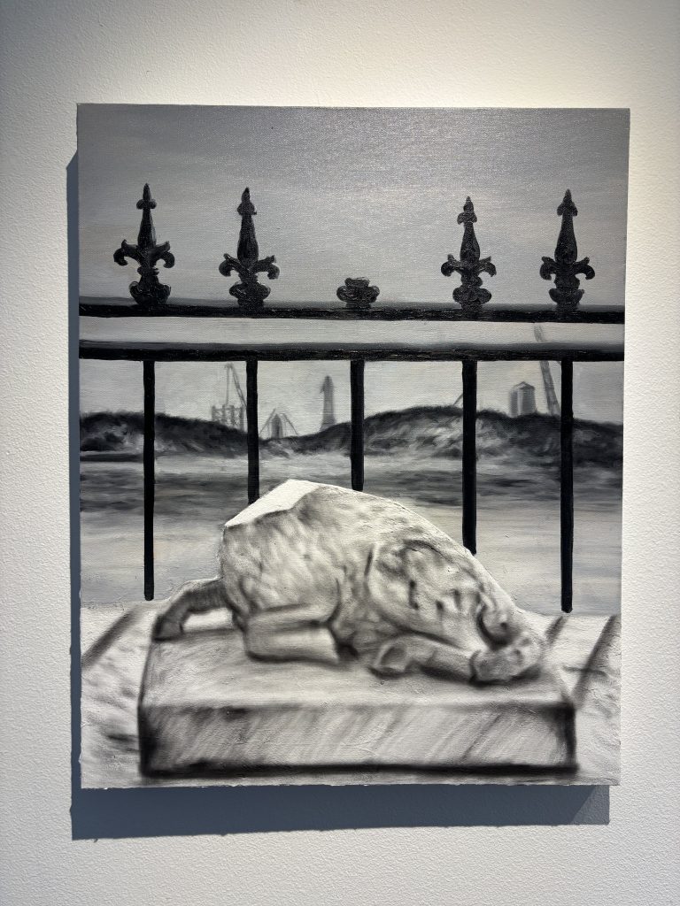 A painted paper-clay lamb, positioned closest to the viewer, draws from a stone cemetery monument. In the background, SpaceX architecture emerges, with burglar bars separating the headless, innocent lamb from these structures.