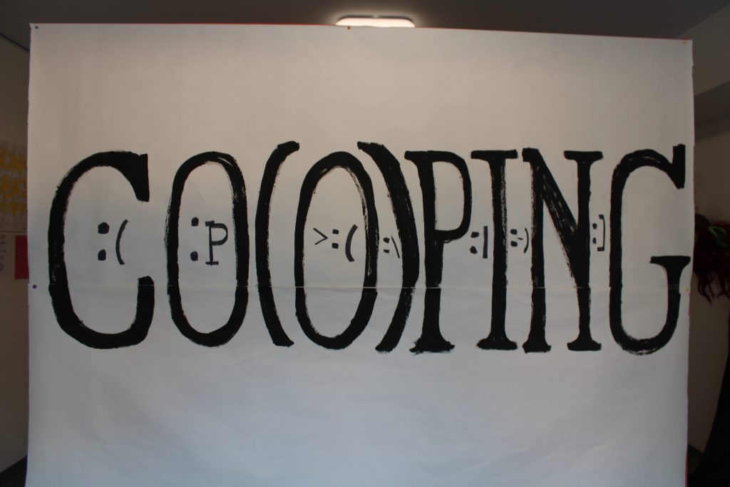 A sign with the word "CO(O)PING."