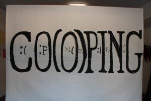 A sign with the word "CO(O)PING."