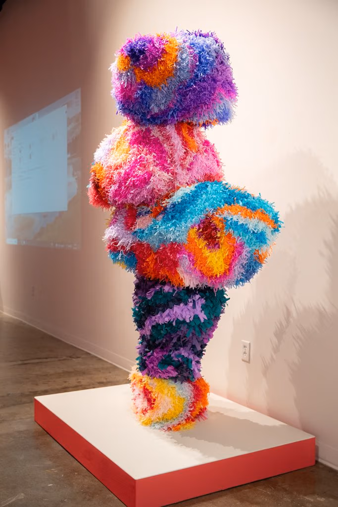 Josuè Ramirez, “Dancing Formation,” 2025; colorful humanoid pinata person in a dancing formation on display at a museum.